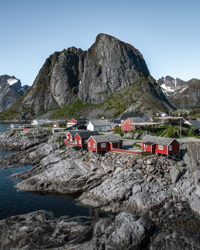 Beautiful Norwegian village by the sea with stunning mountain backdrop in Lofoten.